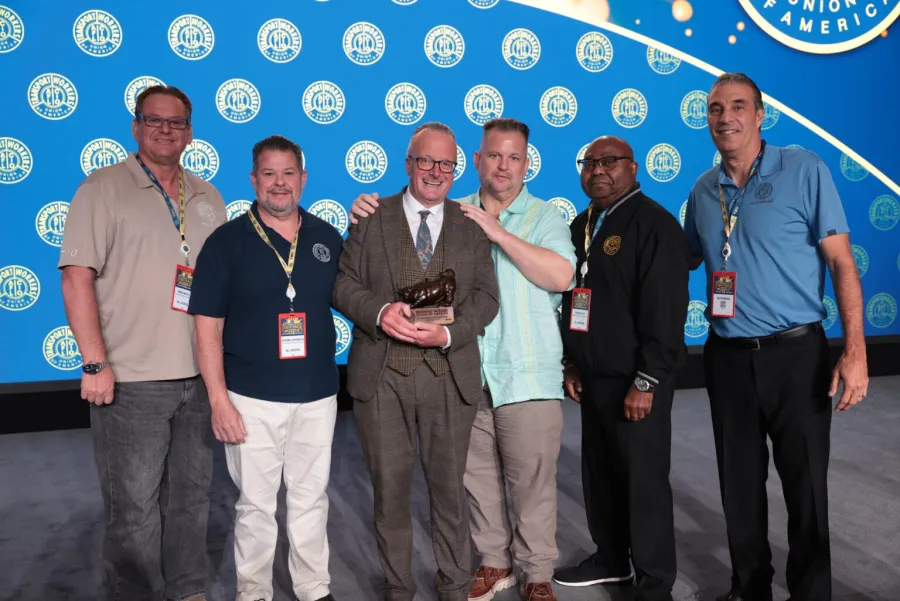TWU leadership poses with labor historian Lorcan Collins at the TWU International Convention.